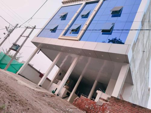 a building with blue windows on top of it at Hotel O DP Palace in LKO
