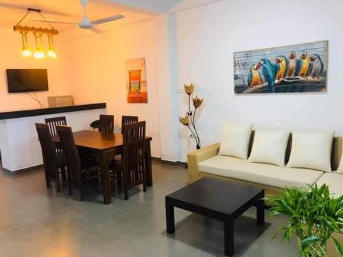 a living room with a couch and a table at Tikla safari lodge in Udawalawe