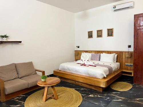 a bedroom with a bed and a couch at Oasis Nungwi in Kendwa Mchangani