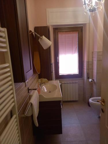 a bathroom with a sink and a window at La casa del nespolo in Massa