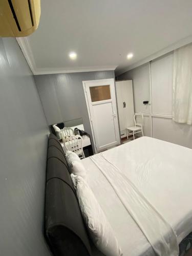 a bedroom with a large white bed in a room at Ezel Group Hotel in Antalya