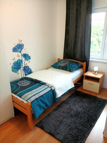 a small bedroom with a bed and a window at Apartman Petra in Senj