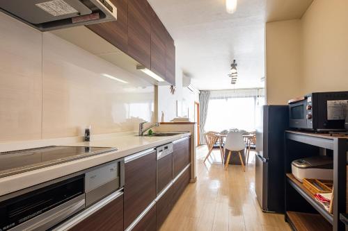 a kitchen with a sink and a stove top oven at Spacious Living and Garden 10 min walk from Shizuoka station in Shizuoka