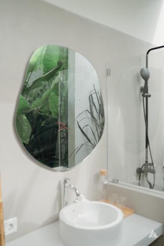 a bathroom with a mirror and a sink at Skutik House in Tanah Lot