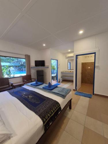 a large bedroom with a large bed and a fireplace at Lanta Island Resort in Ko Lanta