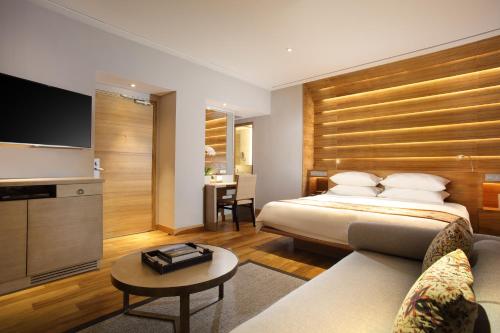 a hotel room with a bed and a tv at Padma Resort Legian in Legian