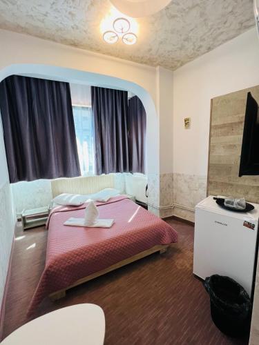 a bedroom with a bed and a tv in it at Hotel AmA in Constanţa