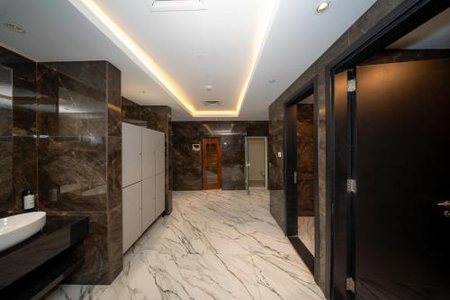 a large bathroom with a sink and a toilet at City Stay Grand Hotel Apartments - Al Barsha in Dubai