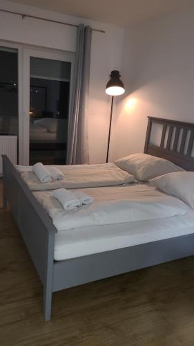 a large bed with two white towels on it at Schöne, gemütliche möblierte 2 Zi Wohnung in RGB in Regensburg