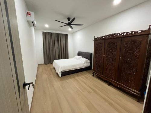 a bedroom with a bed and a ceiling fan at CasaD'Tamarind Homestay with Private Pool in Alor Setar