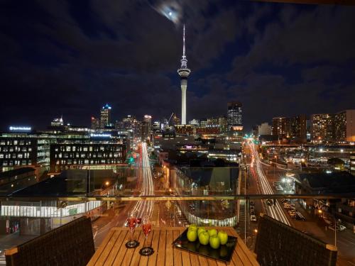 a view of a city at night with a tower at Swiss-Belsuites Victoria Park Auckland in Auckland