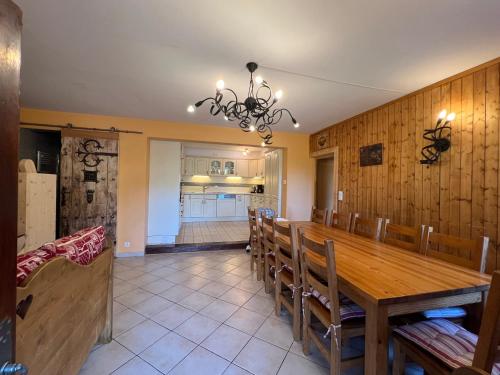 a dining room with a wooden table and chairs at La Maison des Coeurs in Lugrin