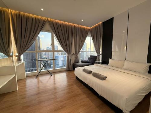 Ένα ή περισσότερα κρεβάτια σε δωμάτιο στο Quill Residence by Rainbow Suites