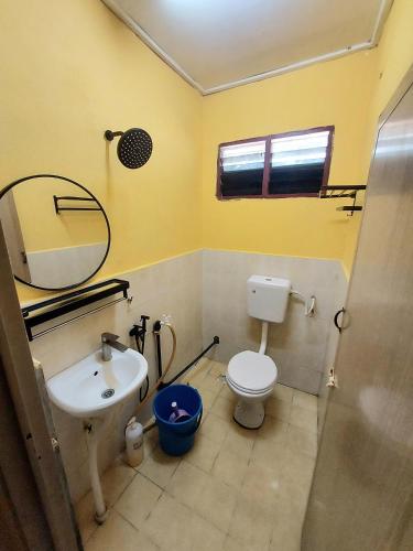a bathroom with a sink and a toilet and a mirror at Irama Resort Amir YJS , Pantai Irama Bachok in Bachok