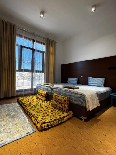 a bedroom with a large bed and a large window at Private Room in Sur House in Sur