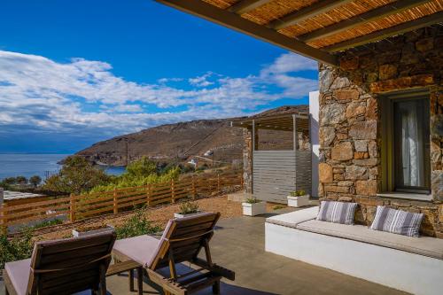 a patio with chairs and a view of the ocean at Remezzo in Ganema