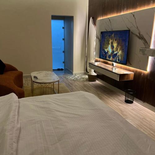 a bedroom with a bed and a couch and a table at Samara in Riyadh