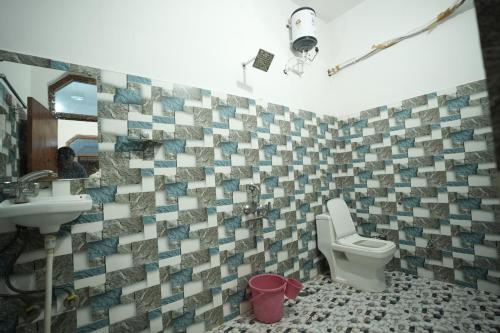 a bathroom with a toilet and a sink at Parkview Hotel in Khajurāho