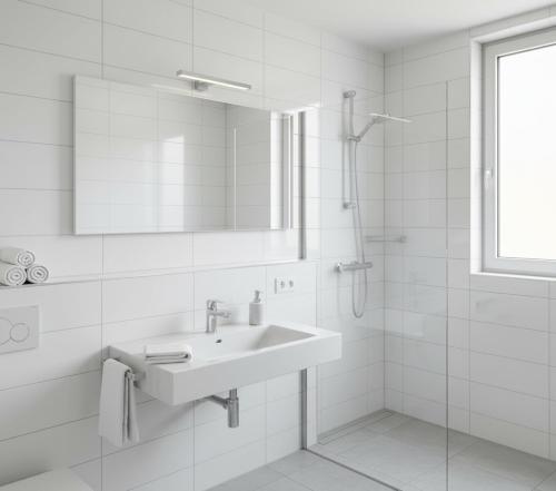 a white bathroom with a sink and a shower at Doksanlar Apart 