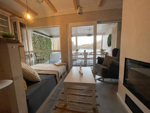 a living room with a couch and a tv at Lake House by Fregata Restaurant in Zagórze Śląskie