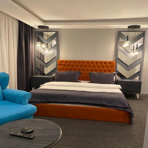 a bedroom with a large bed and a blue couch at Valeron Suit Premium in Istanbul