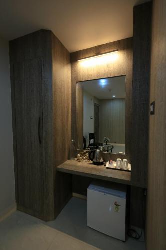 a bathroom with a sink and a mirror at karisma premium in Bhubaneshwar