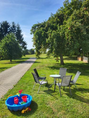 a table and chairs and a table and a table and chairs at Familiennest-Eifel in Blankenheim