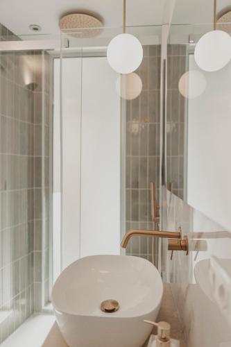 a bathroom with a white sink and a shower at Dimora le Due Sicilie in Cefalù