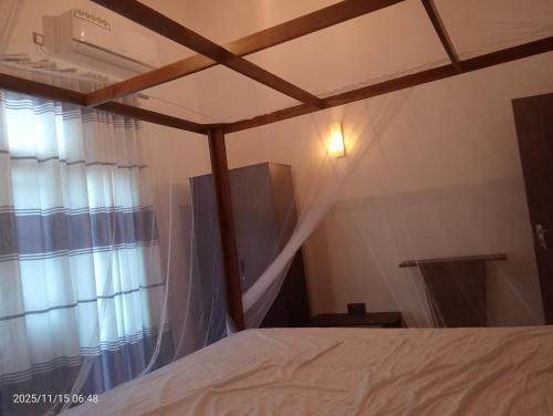 a bedroom with a bed and a window at Angel home villa in Dickwella