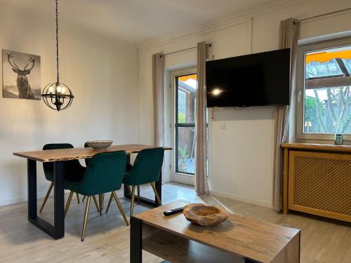 ein Esszimmer mit Tisch und Fernseher in der Unterkunft Alpendomizil Haberspitz in Marquartstein