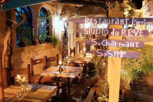 a group of tables in a restaurant with a sign at L'artisan in Hergla
