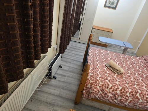 a small bedroom with a bed and a table at Colchester, WIFI, free parking 1 in Hythe