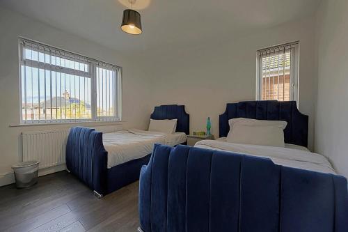 a room with two beds and a couch in it at Comfortable 3-Bed Home - Driveway Parking in Long Eaton