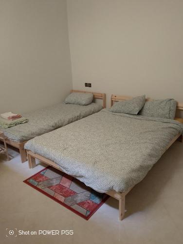 two twin beds sitting in a room at Maison d'hôtes Oujda in Oujda