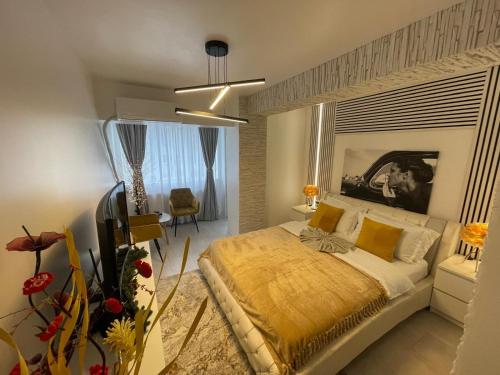 a bedroom with a large bed with a yellow blanket at Apartament Nedianu in Craiova