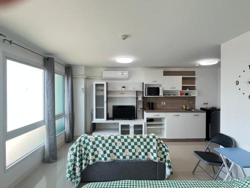a living room with a bed and a kitchen at Bangsaray Beach B414 บางเสร่ บีช รายเดือน in Bang Sare