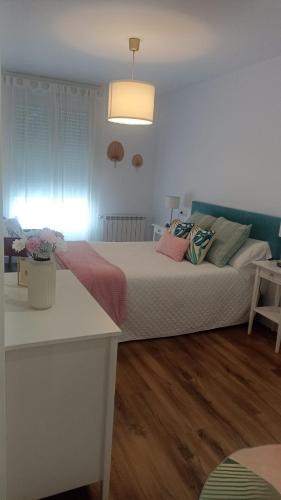 a bedroom with a large bed with pillows on it at Nordés in Vilagarcia de Arousa
