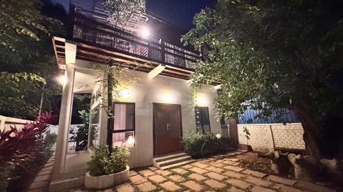 a house with a front porch at night at Terres D'Angkor in Phumĭ Kruŏs
