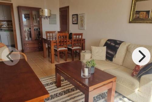 a living room with a couch and a table at Luminoso Terrazas Piscinas Parking in Vera