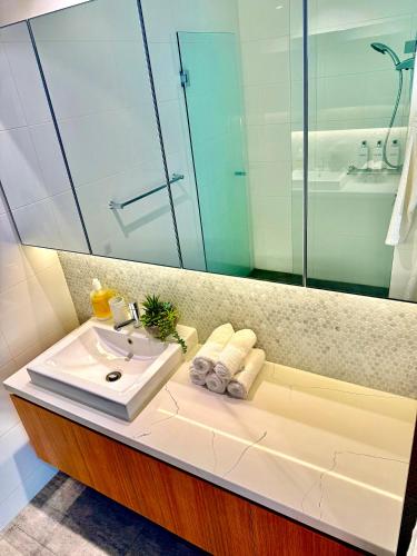 a bathroom with a sink and a mirror at Private Room and bathroom in Shared Apartment with Host in Box Hill