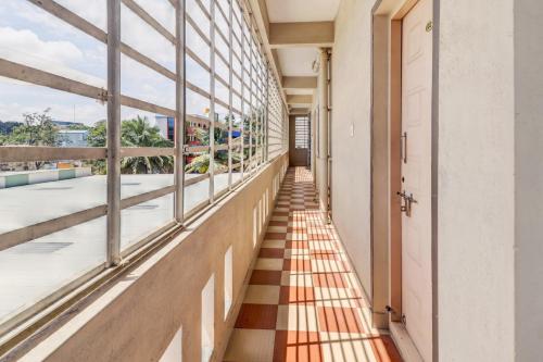 a hallway of an office building with a checkered floor at Collection O Preethi Boarding & Lodging in Kammasandra