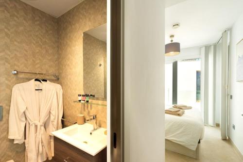 a bathroom with a sink and a bed at Breathtaking Bay views Nerja in Torrox