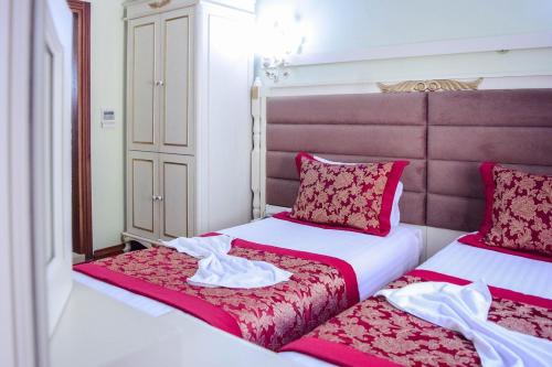 two beds sitting next to each other in a room at Hotel SPHENDON in Istanbul