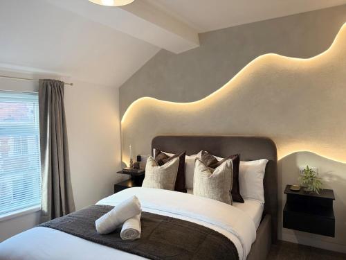 a bedroom with a large bed with white pillows at New Modern 2 Bedroom Central Apt Greater Manchester, Sleeps 5, Near Airport with Great Transport Links in Stockport