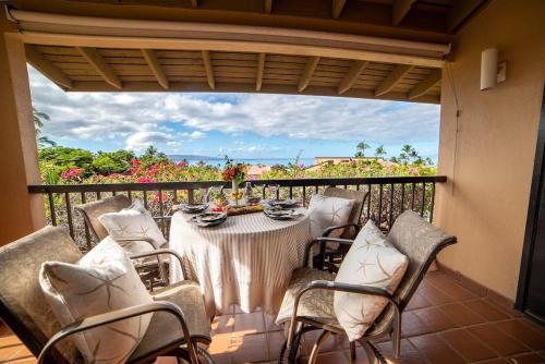 a table and chairs on a balcony with a view at Wailea Ekahi 17D · WEK 17D Wailea Retreat w Ocean View Pool AC in Wailea