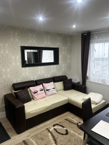a living room with a couch and a mirror at DAVID Resident in Cavnic