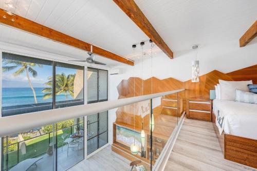 a bedroom with a bed and a view of the ocean at Napili Point C3 · NP C3 Renovated OceanFront to Whale Watch Rela in Kahana