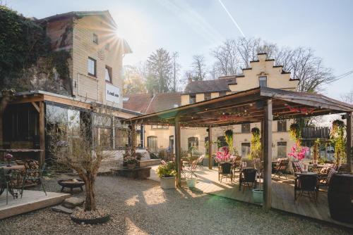 a house with a patio with tables and chairs at LouLou in Berg en Terblijt