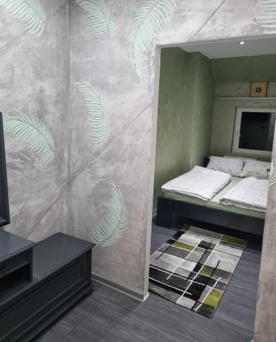 a small room with two beds and a tv at CARPE DIEM Unique S&P in Valjevo
