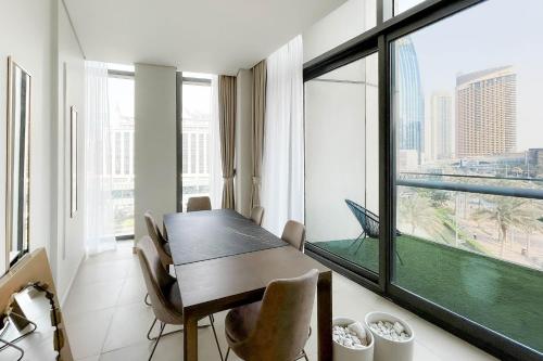 a dining room with a table and a large window at Luxurious 3 BR with Burj Khalifa View in Downtown in Dubai